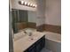 Bright bathroom featuring a single sink vanity with modern fixtures and a shower-tub combo at 1621 Sandecker Ct # 104, Las Vegas, NV 89146