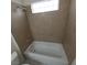 Bathtub featuring neutral tile, updated fixtures, and natural light at 1621 Sandecker Ct # 104, Las Vegas, NV 89146