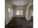 Bright dining room featuring neutral carpet and natural light from a large window at 1621 Sandecker Ct # 104, Las Vegas, NV 89146