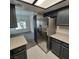 Kitchen with stainless steel refrigerator, neutral countertops and views to the dining room at 1621 Sandecker Ct # 104, Las Vegas, NV 89146