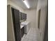 Laundry room with washer, dryer, cabinet space, and modern lighting at 1621 Sandecker Ct # 104, Las Vegas, NV 89146