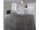Spacious living room with neutral gray carpet, fireplace, and open layout at 1621 Sandecker Ct # 104, Las Vegas, NV 89146