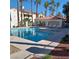 Sparkling community pool with jacuzzi, seating area, and palm trees at 1621 Sandecker Ct # 104, Las Vegas, NV 89146