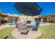 Spacious backyard featuring a pool and an outdoor seating area under a large umbrella at 1709 Chapman Dr, Las Vegas, NV 89104
