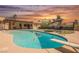 Beautiful backyard oasis with a pool, artificial lawn, dive board, lush landscaping, and outdoor seating area at 1709 Chapman Dr, Las Vegas, NV 89104