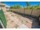View of backyard area with a tall wooden fence, and scattered pavers at 1709 Chapman Dr, Las Vegas, NV 89104