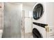 Bathroom featuring a shower with glass door and stackable washer and dryer unit at 1709 Chapman Dr, Las Vegas, NV 89104