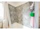 Modern bathroom features a shower with gray tile and a built-in caddy for storage at 1709 Chapman Dr, Las Vegas, NV 89104