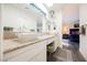 Bright bathroom features double sinks, granite counters, skylight, and an open bedroom layout, creating a serene and spacious retreat at 1709 Chapman Dr, Las Vegas, NV 89104