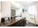 Bright bathroom featuring a single sink vanity, neutral color palette, and decorative elements at 1709 Chapman Dr, Las Vegas, NV 89104