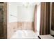 This elegant bathroom features a soaking tub under a chandelier and natural light, perfect for relaxation and spa-like experience at 1709 Chapman Dr, Las Vegas, NV 89104