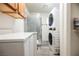Convenient laundry area with stacked washer and dryer and shower stall at 1709 Chapman Dr, Las Vegas, NV 89104