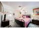Cozy bedroom featuring a bed, nightstands, lamps, and a ceiling fan for a relaxing retreat at 1709 Chapman Dr, Las Vegas, NV 89104