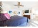 Bedroom features gray flooring, a ceiling fan and a modern mounted television at 1709 Chapman Dr, Las Vegas, NV 89104