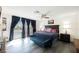 Bedroom with gray flooring, dark curtains, backyard pool view and modern furniture at 1709 Chapman Dr, Las Vegas, NV 89104