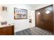 Inviting entryway featuring a patterned rug, artwork, and an entry door at 1709 Chapman Dr, Las Vegas, NV 89104