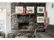 Rustic stone fireplace with decorative mantle and comfortable seating nearby at 1709 Chapman Dr, Las Vegas, NV 89104