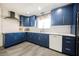 Well-lit kitchen showcasing blue cabinets, white countertops, and modern appliances for an elegant cooking space at 1709 Chapman Dr, Las Vegas, NV 89104