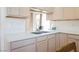 Bright kitchen featuring stainless steel faucet, double bowl sink, and neutral countertops at 1709 Chapman Dr, Las Vegas, NV 89104