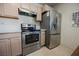 Kitchen boasts stainless steel appliances, including a range, hood, and refrigerator at 1709 Chapman Dr, Las Vegas, NV 89104