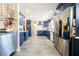 Spacious kitchen with blue cabinets, stainless steel appliances, and patterned wallpaper at 1709 Chapman Dr, Las Vegas, NV 89104
