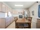 This bright kitchen features a stainless steel refrigerator, cozy eating area and ample counter space, perfect for everyday living at 1709 Chapman Dr, Las Vegas, NV 89104