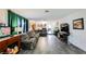 Open-concept living room with a large sectional sofa, striking green curtains, and modern flooring at 1709 Chapman Dr, Las Vegas, NV 89104
