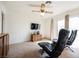 Cozy living room with two leather lounge chairs, ceiling fan, and natural light at 1709 Chapman Dr, Las Vegas, NV 89104