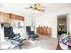 Living room featuring two lounge chairs, a ceiling fan, and natural light at 1709 Chapman Dr, Las Vegas, NV 89104