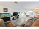 Cozy living room featuring a comfortable sectional, a modern entertainment center, and updated flooring at 1709 Chapman Dr, Las Vegas, NV 89104