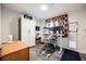 Functional office space with a white desk, monitor setup, and storage cabinet for an efficient workspace at 1709 Chapman Dr, Las Vegas, NV 89104