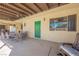 Relaxing outdoor patio featuring comfortable seating, ceiling fans, and a green door, perfect for entertaining at 1709 Chapman Dr, Las Vegas, NV 89104
