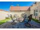 Outdoor living in an outdoor patio with pavers, synthetic grass, and fire pit at 1709 Chapman Dr, Las Vegas, NV 89104