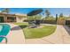 Poolside seating area surrounded by artificial turf at 1709 Chapman Dr, Las Vegas, NV 89104