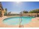 Inviting pool with a diving board surrounded by an artificial lawn, patio seating and blue accents at 1709 Chapman Dr, Las Vegas, NV 89104
