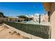 Inviting pool area with seating, mature shade trees, and privacy landscaping at 1709 Chapman Dr, Las Vegas, NV 89104