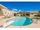 Backyard pool featuring a diving board and poolside lounge chairs under a clear blue sky at 1709 Chapman Dr, Las Vegas, NV 89104