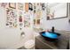 Unique powder room features a striking blue glass bowl sink and decorative wall accents, making a bold and artistic statement at 1709 Chapman Dr, Las Vegas, NV 89104