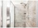 Shower featuring multiple shower heads, beautiful neutral toned tile, and a glass shower door at 1709 Chapman Dr, Las Vegas, NV 89104