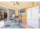 Bright sun room with tile flooring, casual seating, and a large refrigerator, perfect for entertaining at 1709 Chapman Dr, Las Vegas, NV 89104