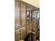 Tall built-in wood cabinets with glass display doors add functionality to the interior at 1801 Calle De Vega, Las Vegas, NV 89102