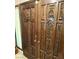 Close up of an ornate, wood double front door with heavy carving and brass hardware at 1801 Calle De Vega, Las Vegas, NV 89102