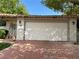 Home's exterior with a two car garage and an ornate gated entry sitting on a brick driveway at 1801 Calle De Vega, Las Vegas, NV 89102