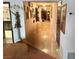 Long hallway with decor and framed photos leading to another room, with wood flooring at 1801 Calle De Vega, Las Vegas, NV 89102