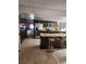 Open kitchen with tile flooring, a stainless fridge, island with stools, and view to the dining room at 1801 Calle De Vega, Las Vegas, NV 89102