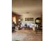 Living room with large L shaped sofa, vintage lamps and decor, and neutral walls and carpet at 1801 Calle De Vega, Las Vegas, NV 89102