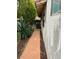 Side yard tiled walkway next to house with various greenery and plants at 1801 Calle De Vega, Las Vegas, NV 89102