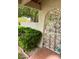 Beautiful white metal entry gate with bushes and trees makes for a charming walkway at 1801 Calle De Vega, Las Vegas, NV 89102