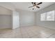 Bright bedroom featuring tiled floors, a ceiling fan, and a spacious closet at 1881 W Alexander Rd # 1135, North Las Vegas, NV 89032