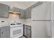 Bright kitchen showcasing a gas range, gray cabinets, and ample counter space at 1881 W Alexander Rd # 1135, North Las Vegas, NV 89032